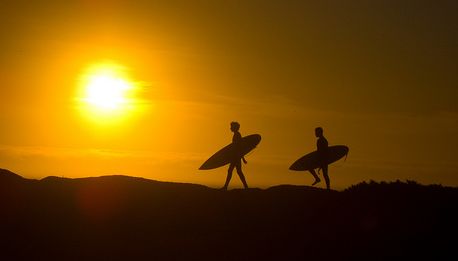 surfing at sunset